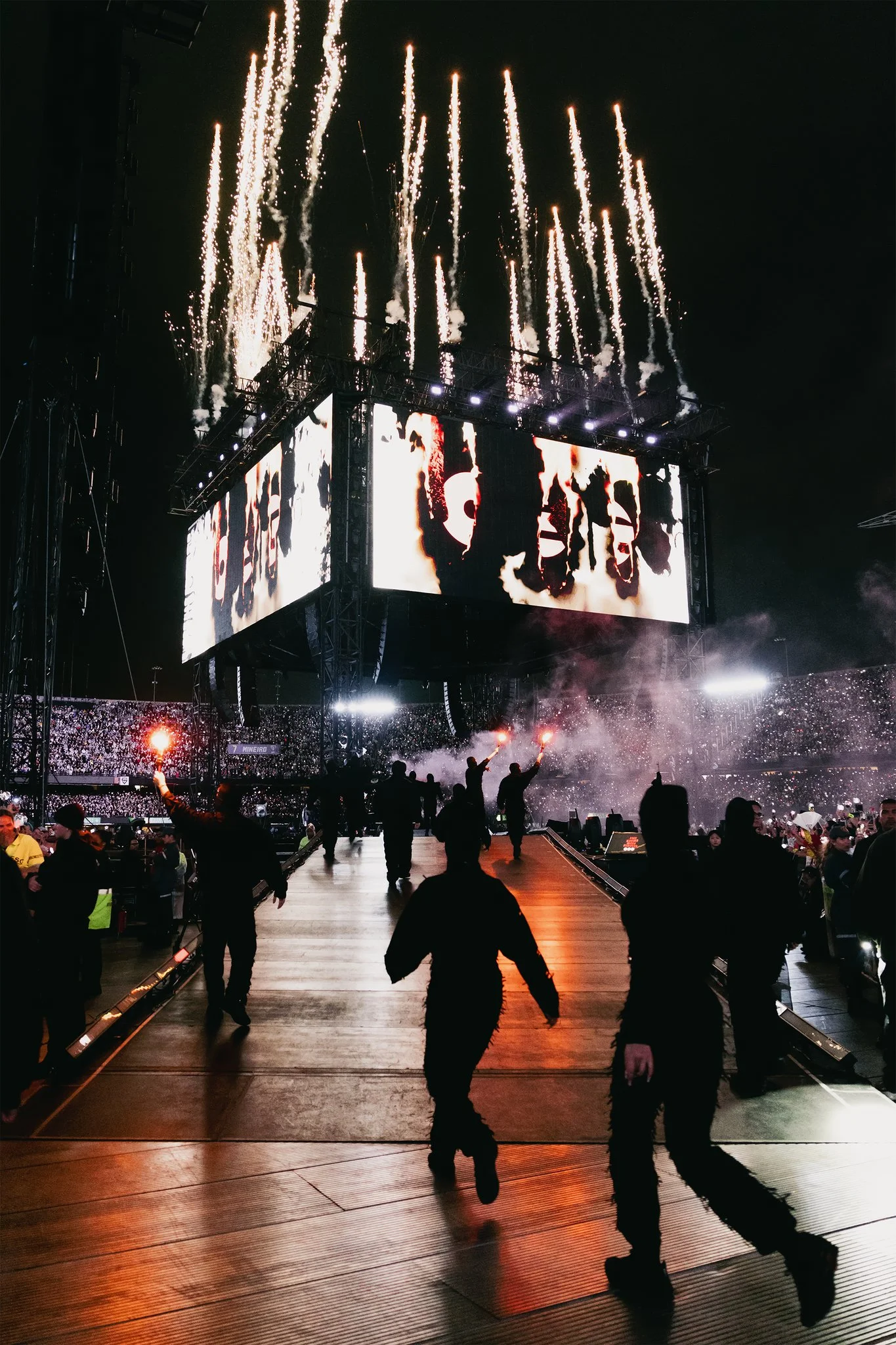 BTS caminha pela passarela do palco 360 graus no MorumBIS com o telão ao fundo